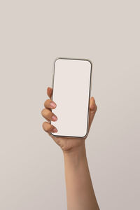 Person holding smart phone over white background