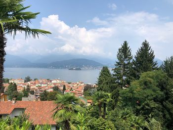 View of city by sea against sky