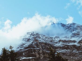 Low angle view of snow covered mountain against sky