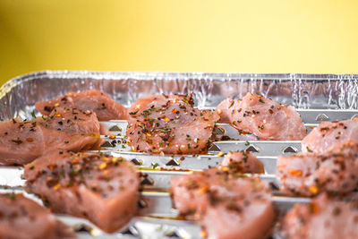 Close-up of raw meat on aluminum foil