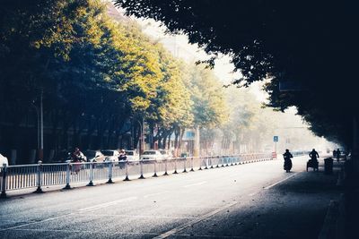 People walking on footpath in city