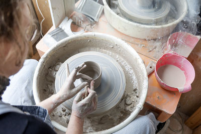 Woman using potters wheel