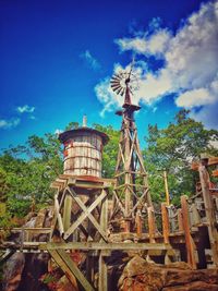 Low angle view of traditional windmill against sky