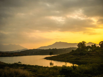 Scenic view of lake against cloudy sky