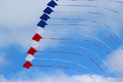 Low angle view of flags against sky