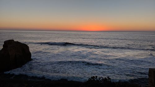 Scenic view of sea against clear sky during sunset