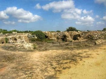 Scenic view of landscape against cloudy sky