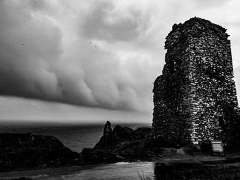 Rocks by sea against sky