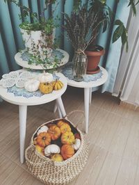 Fruits and potted plants on table at home