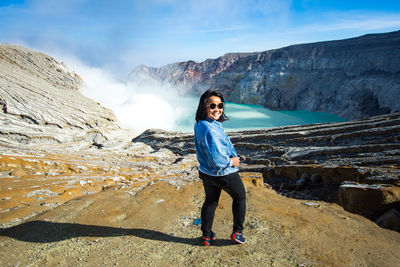 Full length of man standing on rock against mountains