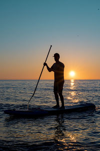 Standup paddle on sunset