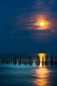 Scenic view of sea against sky during full moon 