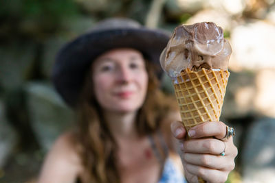 Portrait of woman holding ice cream cone