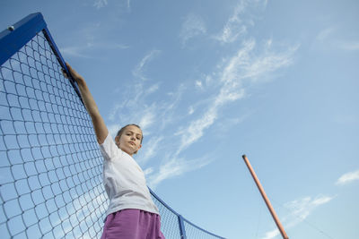 Elevating dreams,  courageous girl reaches for her goals amidst the endless skyline