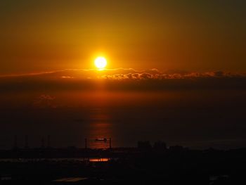 Scenic view of silhouette city against sky during sunset