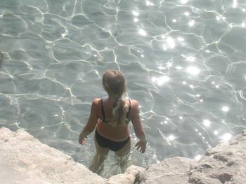High angle view of woman standing in shallow water