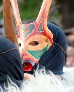 Close-up of person wearing mask at event