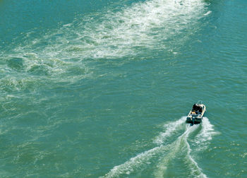 High angle view of man driving boat in sea