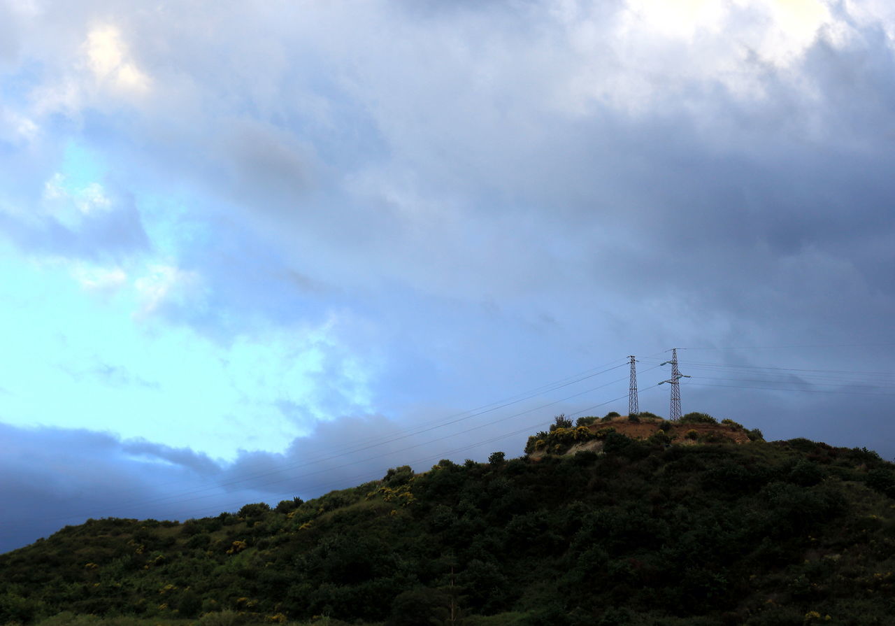 LOW ANGLE VIEW OF ELECTRICITY PYLON AGAINST MOUNTAIN