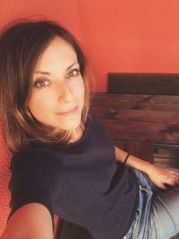 Portrait of smiling young woman sitting at home