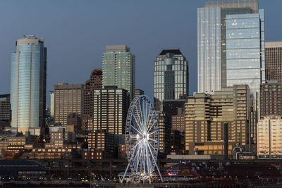 Illuminated cityscape against sky