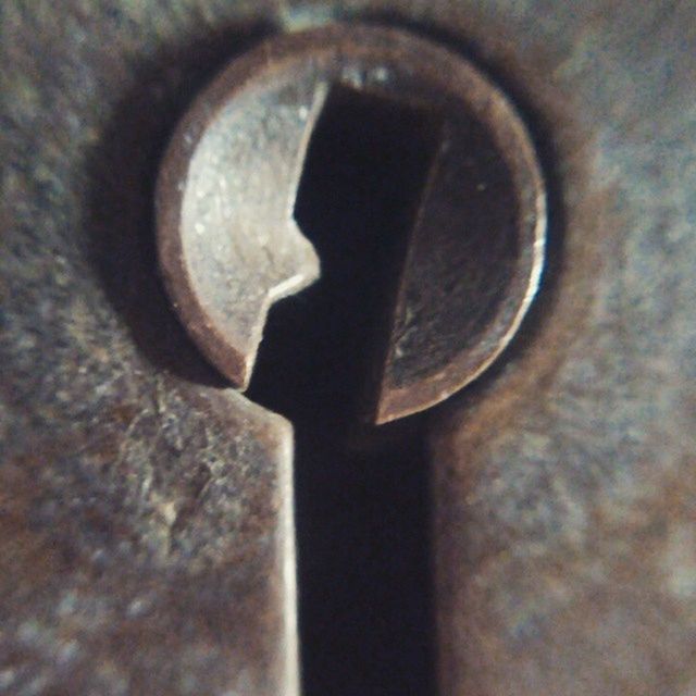 indoors, close-up, selective focus, still life, textured, old, metal, circle, single object, wood - material, part of, no people, focus on foreground, old-fashioned, table, detail, extreme close-up, wall - building feature, macro, hole