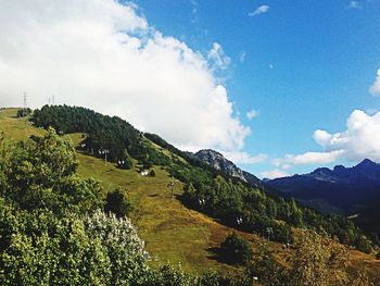 Scenic view of mountains against cloudy sky