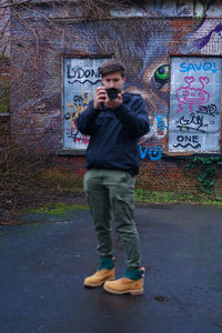 Full length of young man photographing