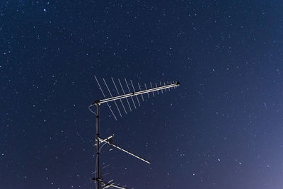 Low angle view of windmill against sky at night