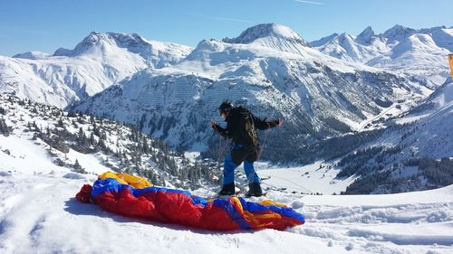 People skiing on snow covered landscape