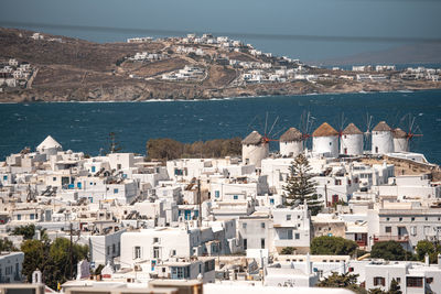 High angle view of townscape by sea against sky