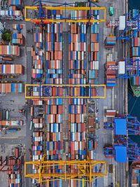 Full frame shot of metallic structure by pier against buildings