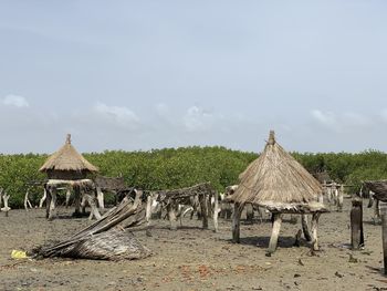 Panoramic view of village on field against sky