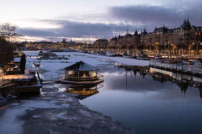 View of buildings in river during winter