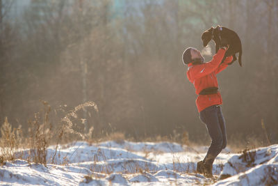 Woman standing on snow covered land