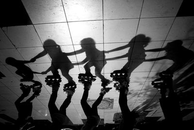 High angle view of people walking on tiled floor