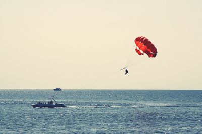 Scenic view of people parasailing