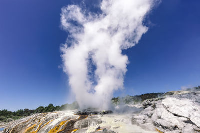 Panoramic view of volcanic mountain against blue sky