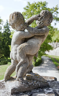 Close-up of angel statue against plants