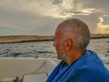 Portrait of man wearing hat against sea against sky