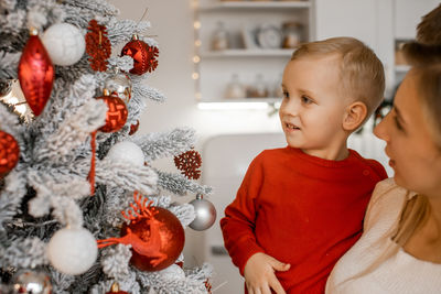 Portrait of cute girl decorating christmas tree