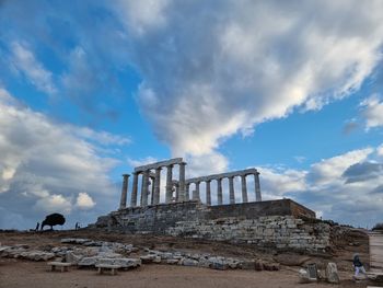 Low angle view of greek ancient temple of god poseidon on the rocks of attica in sounion.