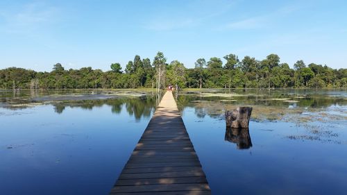 Pier over lake against sky