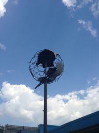 Low angle view of windmill against blue sky