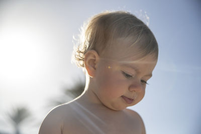 Close-up of baby girl looking down