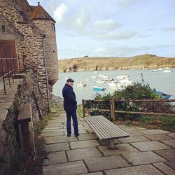 Rear view of man standing against wall