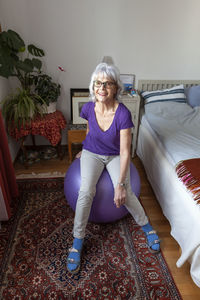 Senior woman sitting on fitness ball