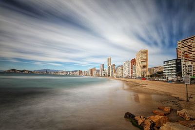Panoramic view of sea and buildings against sky