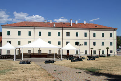 Houses by street against sky in city