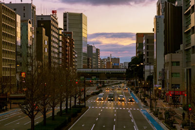 Vehicles on city street amidst buildings